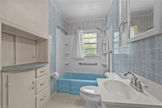 full bath featuring tile patterned floors, shower / washtub combination, toilet, vanity, and tile walls