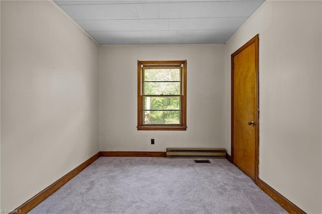 carpeted empty room with baseboards, crown molding, and visible vents