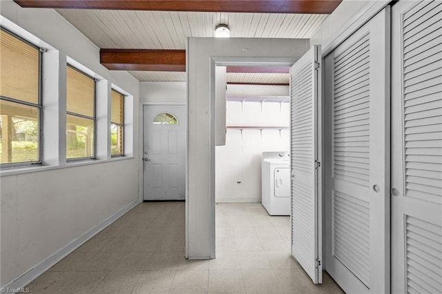 laundry area featuring wood ceiling, baseboards, laundry area, and washer / clothes dryer
