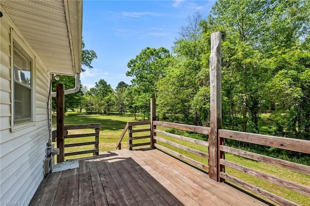 wooden terrace featuring a yard