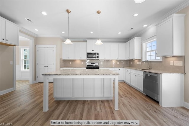 4095 Stallion St Lot 19, High Point, NC 27262 - kitchen with stainless steel appliances, a sink, crown molding, white cabinetry, and recessed lighting