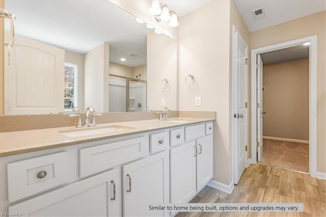 4095 Stallion St Lot 19, High Point, NC 27262 - bathroom featuring wood finished floors, baseboards, a shower stall, and double vanity