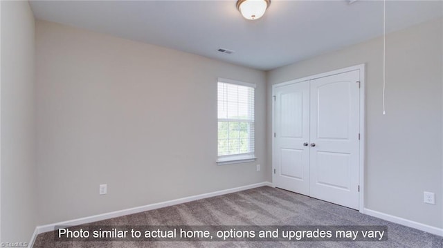 4095 Stallion St Lot 19, High Point, NC 27262 - unfurnished bedroom with carpet floors, a closet, and baseboards
