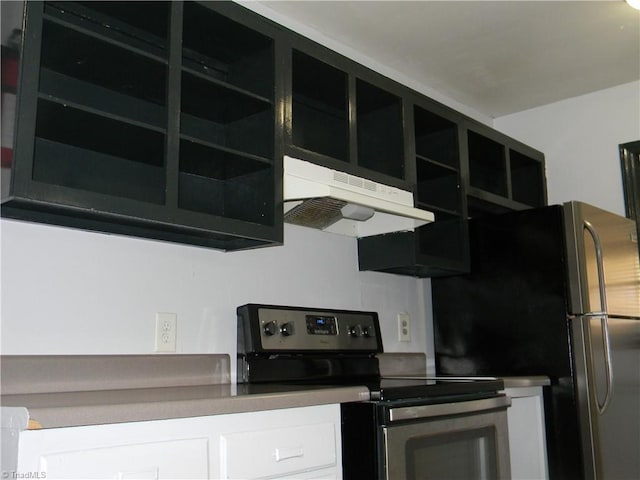 kitchen with stainless steel fridge, electric range, and extractor fan