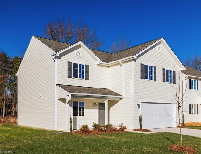 view of front facade with a front yard and a garage