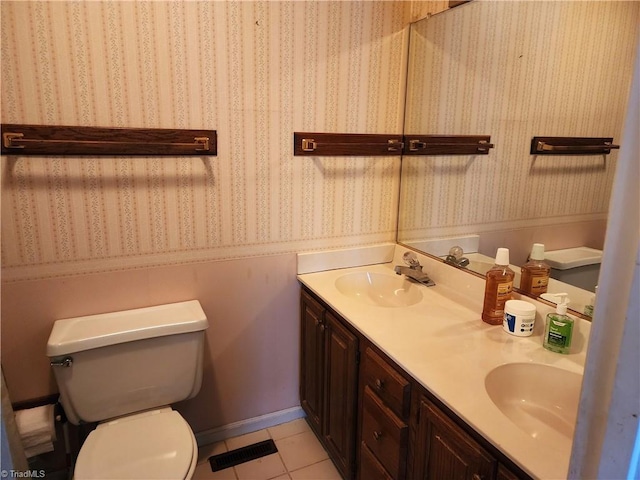 bathroom with tile patterned floors, a sink, toilet, and wallpapered walls