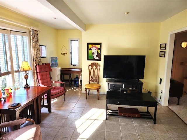 living area with baseboards and light tile patterned floors