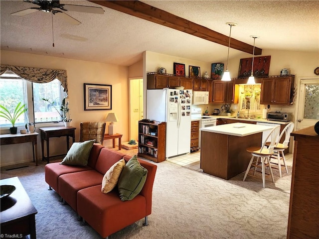 kitchen with lofted ceiling with beams, a breakfast bar area, white appliances, light countertops, and pendant lighting