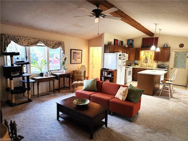 living area with a toaster, vaulted ceiling with beams, a ceiling fan, light carpet, and a textured ceiling