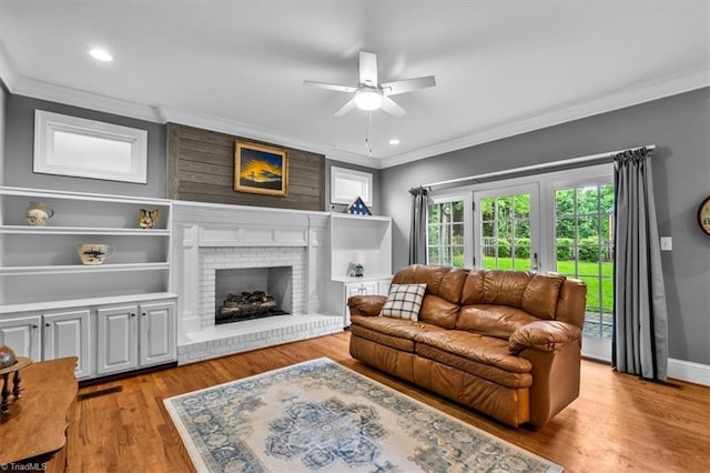 6 Yardarm Ct, Greensboro, NC 27455 - living area featuring ornamental molding, a ceiling fan, wood finished floors, a brick fireplace, and recessed lighting