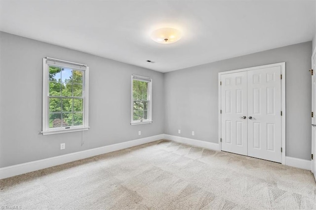 6 Yardarm Ct, Greensboro, NC 27455 - unfurnished bedroom with baseboards, a closet, and carpet floors