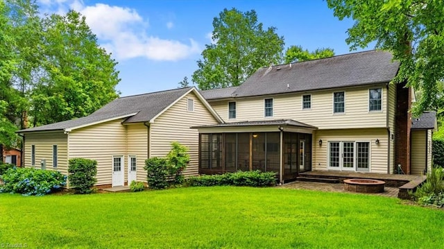 6 Yardarm Ct, Greensboro, NC 27455 - back of property featuring a sunroom, an outdoor fire pit, and a lawn