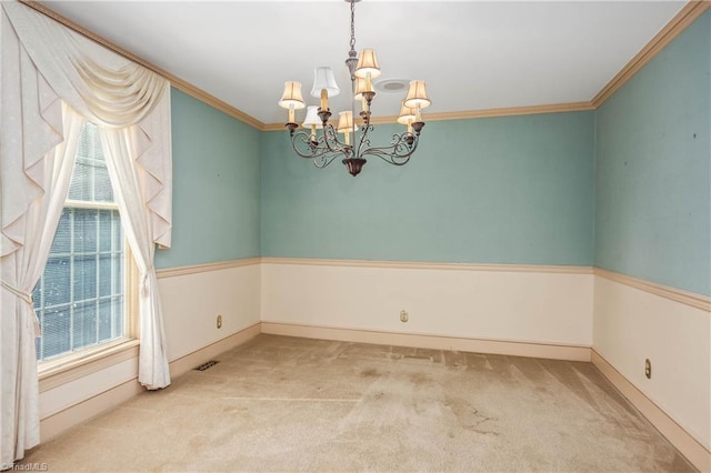 empty room featuring light carpet, ornamental molding, a chandelier, and a wealth of natural light