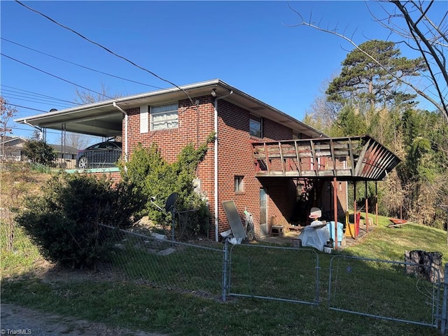 925 S Franklin Rd, Mount Airy, NC 27030 - view of home's exterior featuring a carport, a lawn, fence, brick siding, and a wooden deck