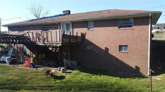 925 S Franklin Rd, Mount Airy, NC 27030 - back of house with brick siding, a wooden deck, a chimney, and a lawn