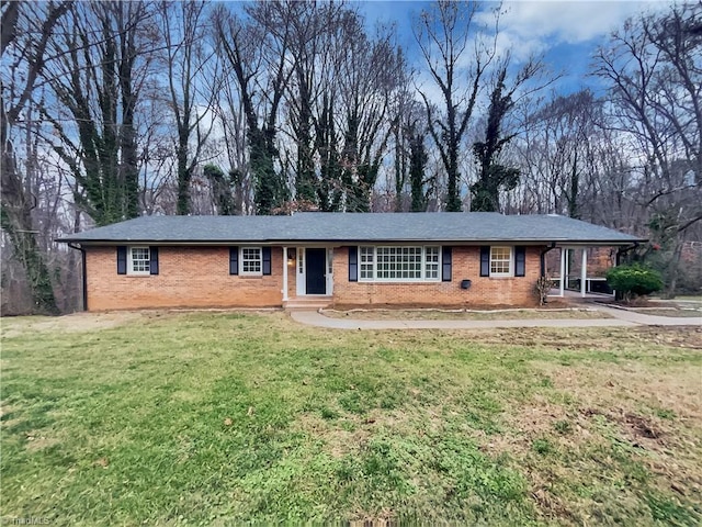 ranch-style home with a front yard and a carport