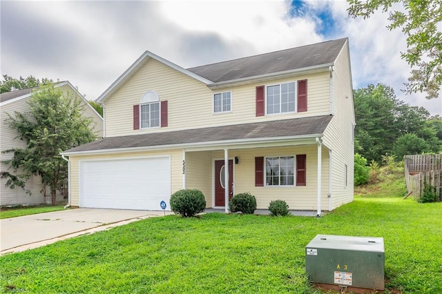 traditional home featuring a garage, a front yard, and concrete driveway