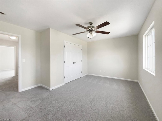 unfurnished bedroom featuring a closet, carpet flooring, and ceiling fan