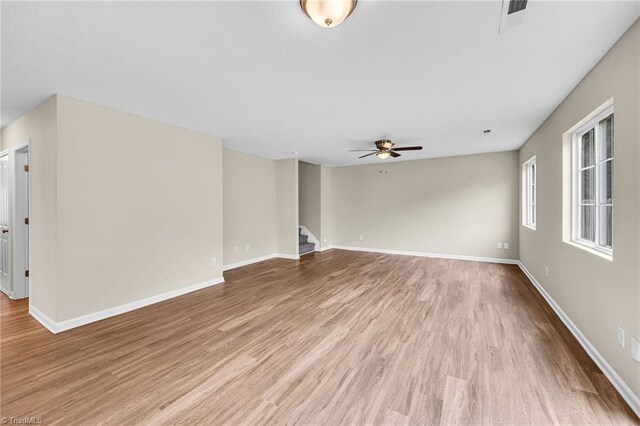 empty room featuring carpet floors and ceiling fan