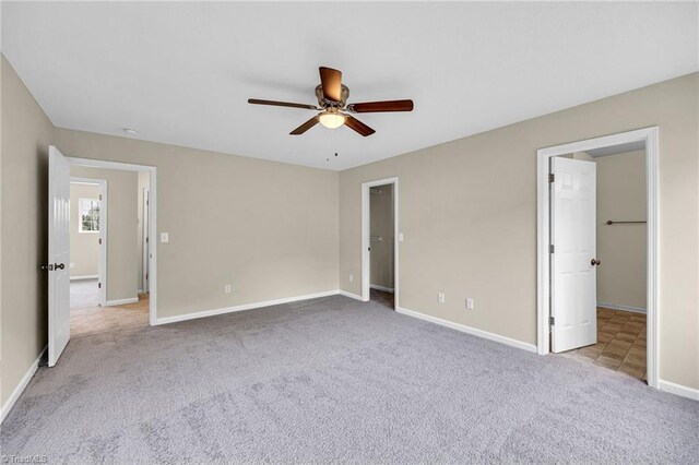 unfurnished bedroom with light colored carpet and ceiling fan