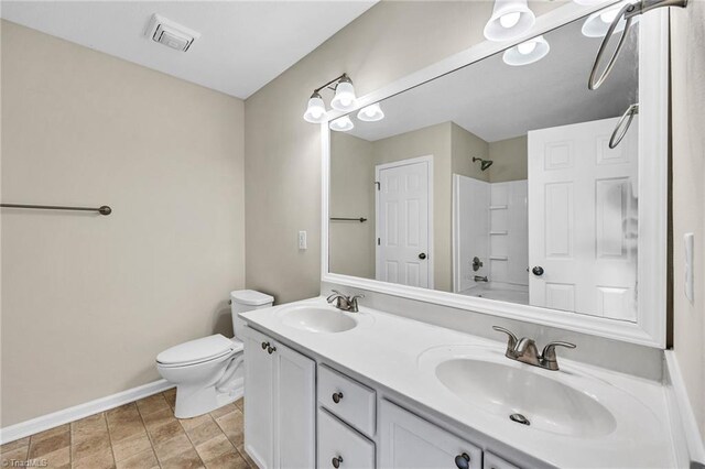 full bathroom featuring dual vanity, toilet, tile patterned floors, and washtub / shower combination