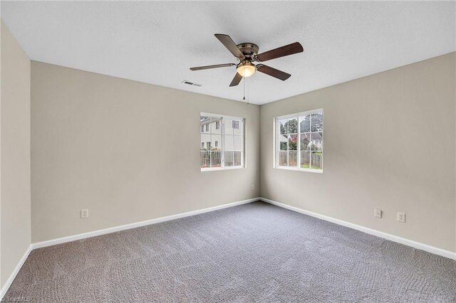 spare room with carpet floors and ceiling fan