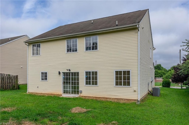 back of property featuring a lawn and central AC unit