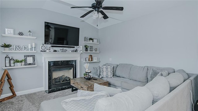 living room featuring a fireplace, ceiling fan, and lofted ceiling