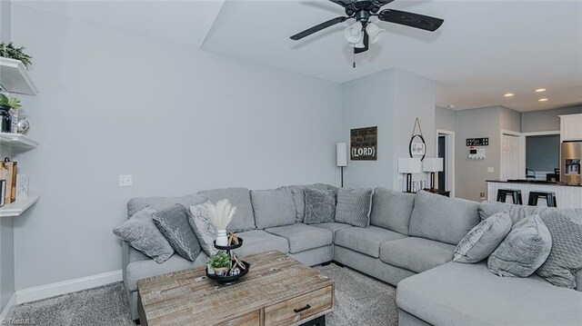 living room with ceiling fan and carpet floors