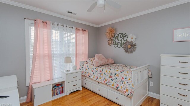 bedroom with light hardwood / wood-style floors, ceiling fan, and crown molding