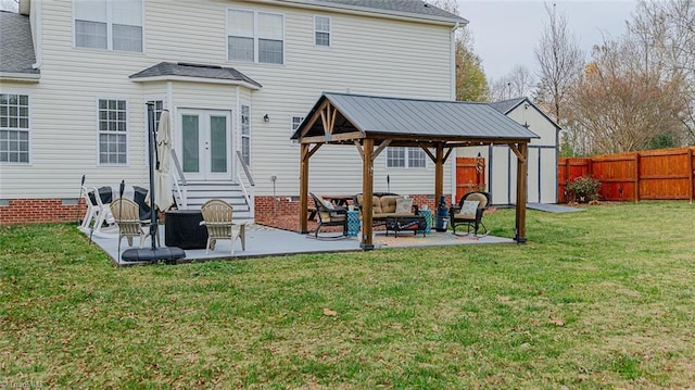 rear view of house featuring french doors, an outdoor living space, a gazebo, a yard, and a patio