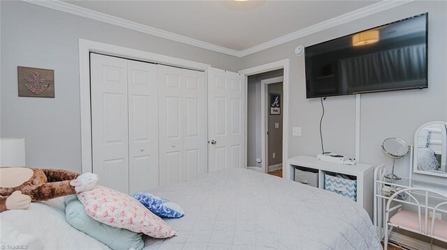 bedroom with a closet and ornamental molding