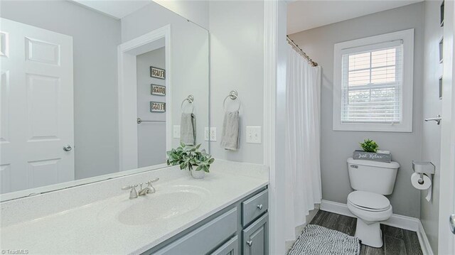 bathroom with hardwood / wood-style flooring, vanity, and toilet