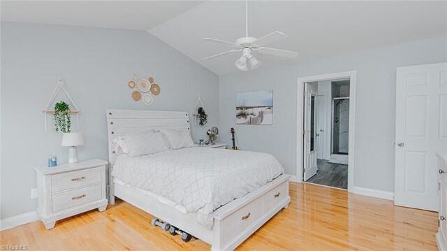 bedroom featuring ceiling fan, lofted ceiling, ensuite bathroom, and light hardwood / wood-style flooring