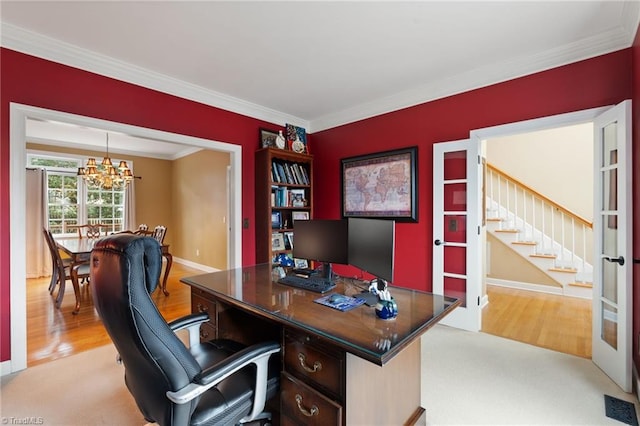 office with light wood-type flooring, crown molding, french doors, and an inviting chandelier