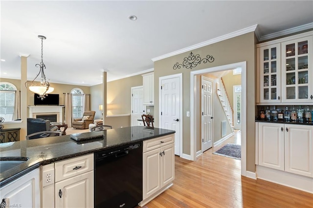 kitchen with white cabinets, pendant lighting, black dishwasher, and dark stone countertops