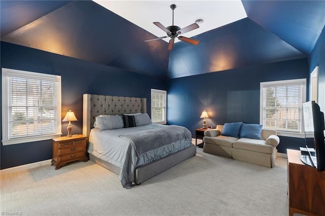 bedroom with ceiling fan, carpet flooring, vaulted ceiling, and multiple windows