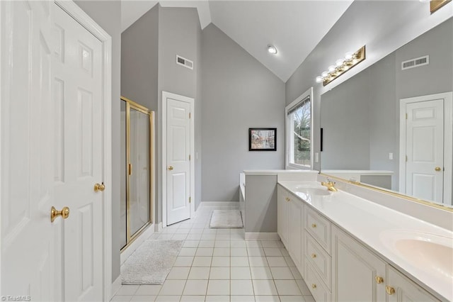 bathroom with plus walk in shower, vaulted ceiling, tile patterned floors, and vanity