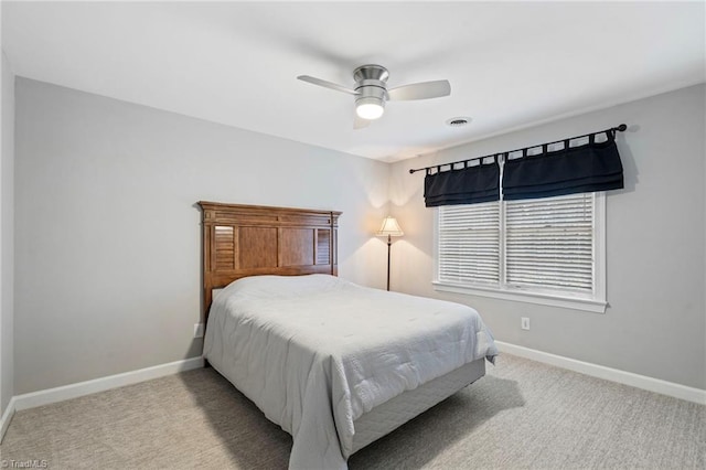 bedroom featuring ceiling fan and light carpet