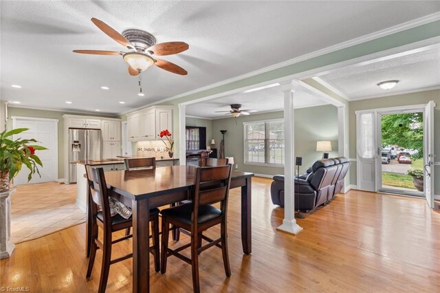 510 Hampton Dr, King, NC 27021 - dining room featuring a ceiling fan, decorative columns, ornamental molding, light wood-style flooring, and baseboards