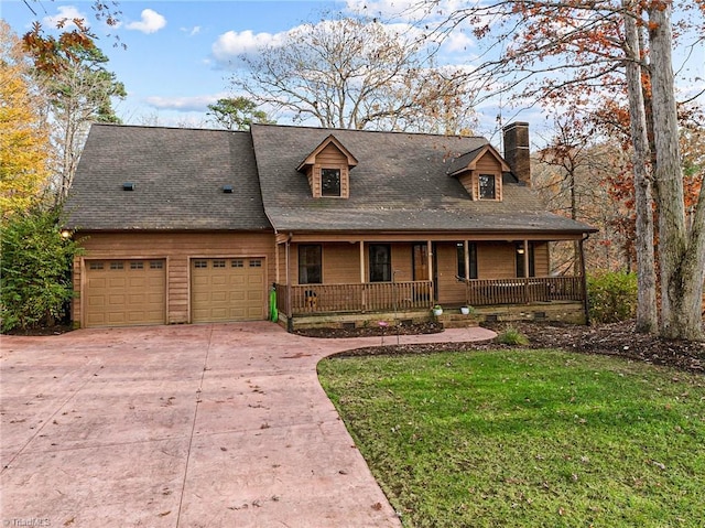 view of front of property with covered porch, a garage, and a front lawn