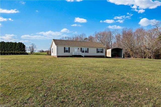 rear view of house featuring a yard and a carport