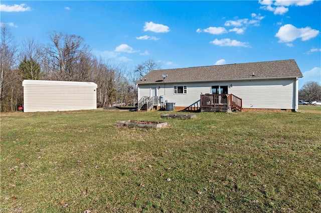 rear view of house with a lawn and a deck