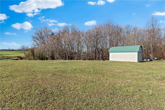 view of yard featuring a rural view and a storage shed