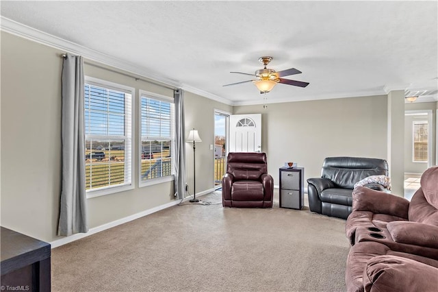 carpeted living room featuring ceiling fan and crown molding