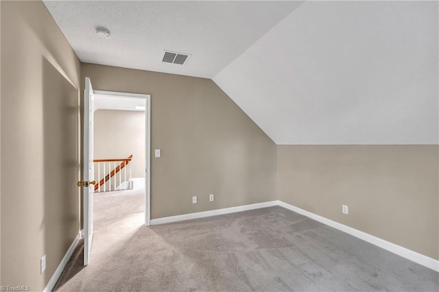 bonus room featuring carpet floors, lofted ceiling, and baseboards