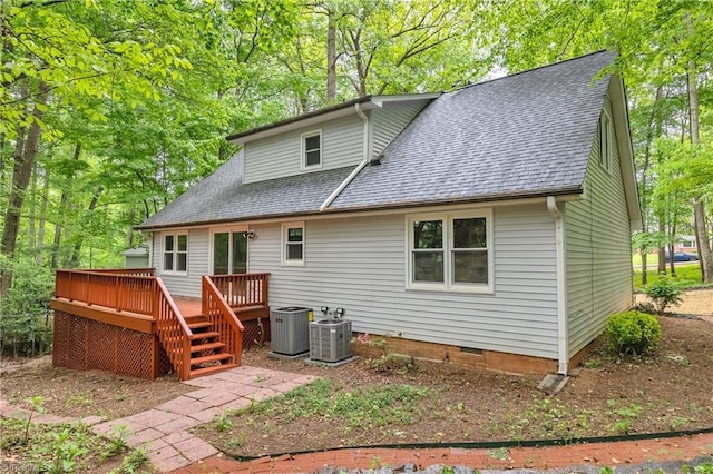 rear view of house with roof with shingles, central AC unit, crawl space, and a deck
