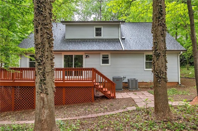 rear view of property featuring a shingled roof, a deck, and central air condition unit