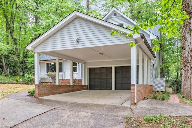 view of front of house with driveway, a garage, and brick siding