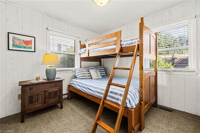 carpeted bedroom featuring baseboard heating